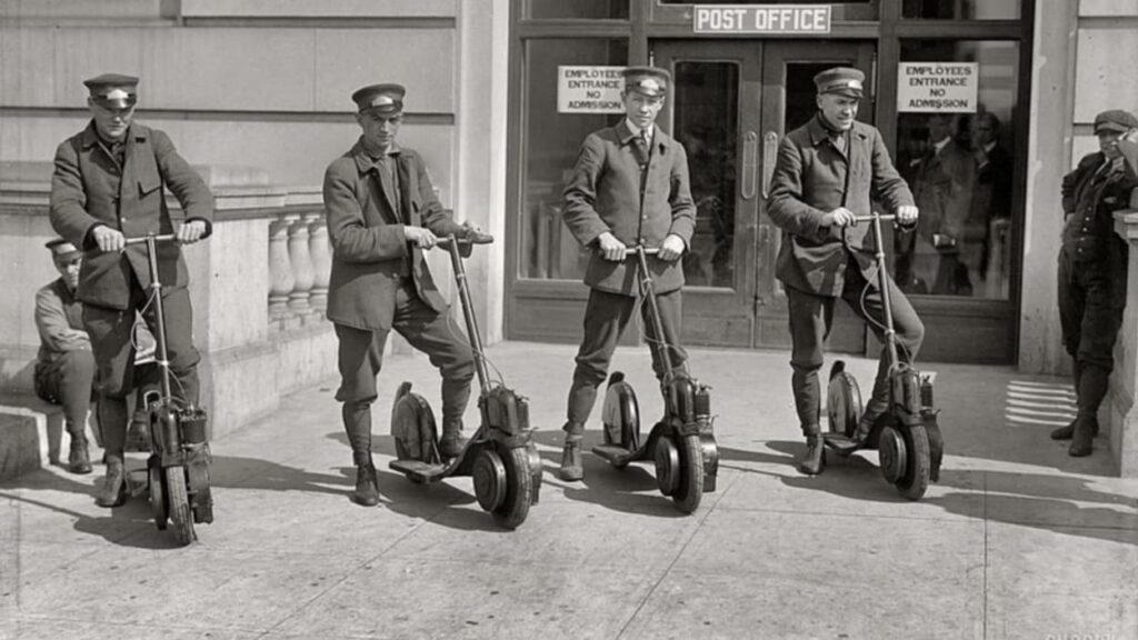 Four special delivery postmen for the U.S. Postal Service try out new scooters in the mid-1910s